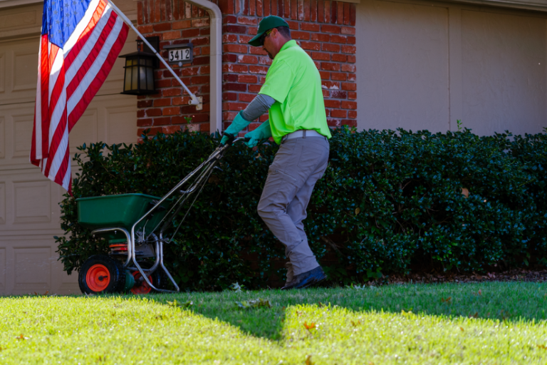 image of a lawn care professional treating a lawn